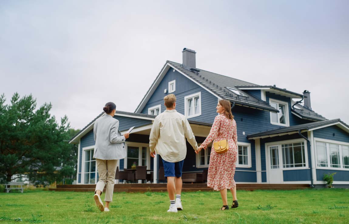 People looking at a home on lawn